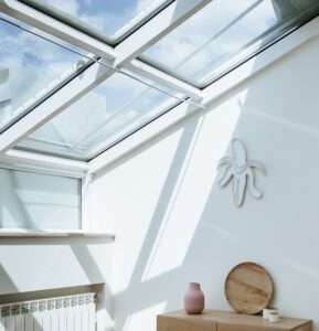 large roof windows overlooking a room without solar powered skylight blinds